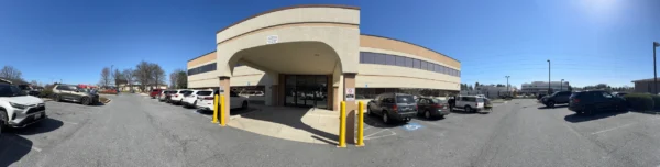 Exterior view of a modern two‑story medical office building with convenient parking in Frederick, MD—home to a trusted chiropractor for neck pain relief.