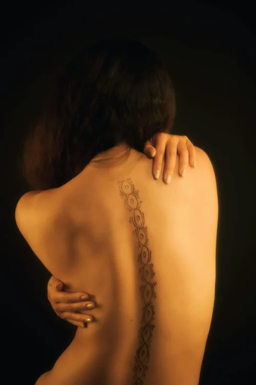 A lady suffering from severe back pain and needs a herniated disc chiropractor.