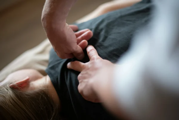 Close-up of a therapist performing a chiropractic massage on a patient's upper back — ideal for those searching for chiropractic massage near me.