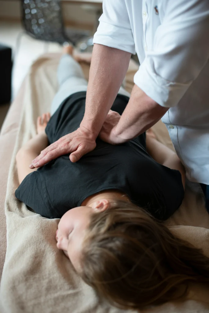 Patient receiving a full back adjustment during a chiropractic massage—perfect for those searching for chiropractic massage near me.